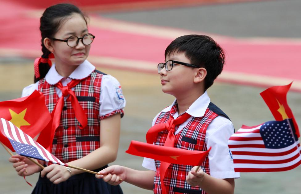 Học sinh tiểu học vẫy cờ Việt Nam – Mỹ chào đón chuyến thăm của Tổng thống Mỹ đến Hà Nội