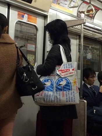 Một chiếc túi thời trang làm từ bao bì cám con cò được một bạn trẻ ở Nhật Bản đeo trong một chuyến tàu điện ngầm.