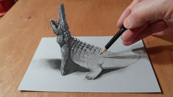 Hình ảnh cá sấu đang vươn hình giống như một món đồ chơi thực thụ được đặt trên trang giấy