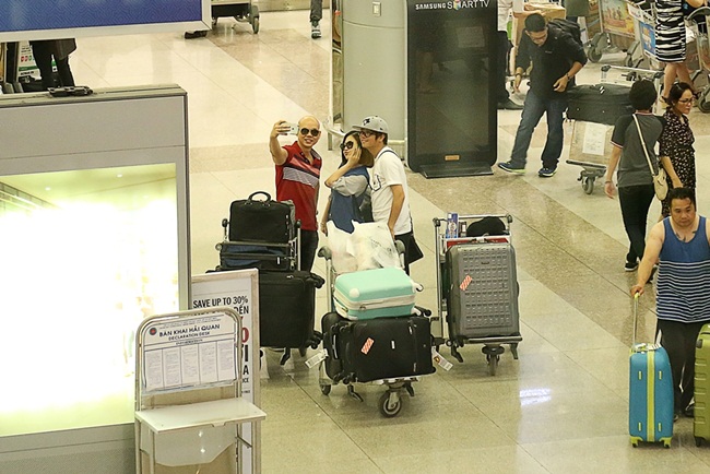 Cặp đôi còn được nhiều hành khách trong sân bay nhận ra và xin chụp hình cùng.