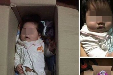 Bé gái bụ bẫm đáng yêu, không khóc khi bị bỏ rơi trong thùng giấy