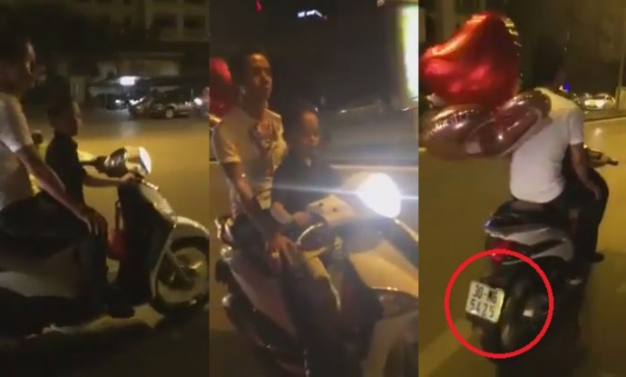 Hình ảnh trong clip người cha để bé lái xe máy Liberty phóng vù vù trên phố và không đội mũ bảo hiểm