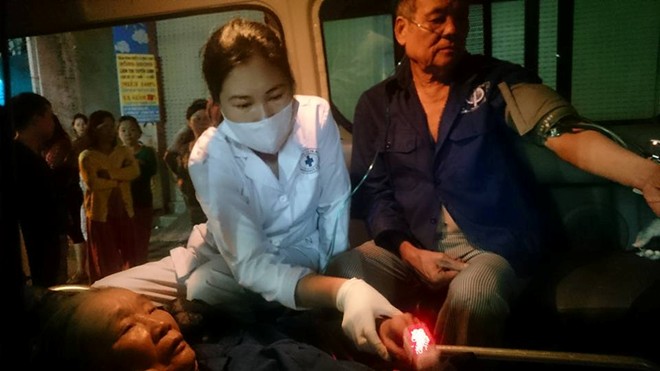Nhân viên y tế kiểm tra sức khỏe của nạn nhân trong vụ cháy nhà ở Hà Nội