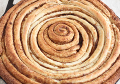 Làm nóng lò ở 205 độ C trong 10 phút, sau đó cho bánh vào nướng trong khoảng 18 đến 25 phút. Để làm phần glaze trên mặt bánh, trộn tất cả các nguyên liệu phần glaze lại với nhau. Khi bánh vừa nướng xong, đổ ngay hỗn hợp lên mặt bánh nóng, trang trí thêm với vỏ cam tuỳ thích.