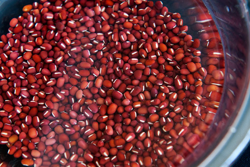 Đem toàn bộ chỗ đậu đỏ ngâm trong nước 3 – 4 tiếng cho đậu nở, rồi đem hấp chín với lượng đường phù hợp trong vòng 15 phút kể từ khi nước sôi để đậu chín bở.