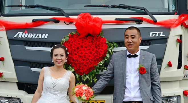Cô dâu và chú rể hạnh phúc bên chiếc xe tải đầy hoa tươi trong đám cưới