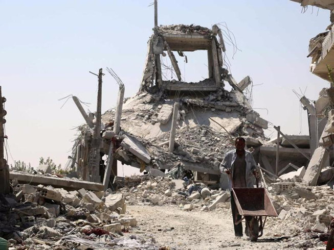 Chiến sự Syria: Cảnh đổ nát ở Manbji, gần ngôi làng bị không kích. Ảnh: Getty Images 