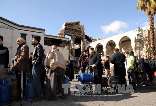  Chiến sự Syria: Người dân Syria xếp hàng chờ mua gas trong không khí yên bình ở Damascus ngày 30/12. Ảnh: EPA/TTXVN