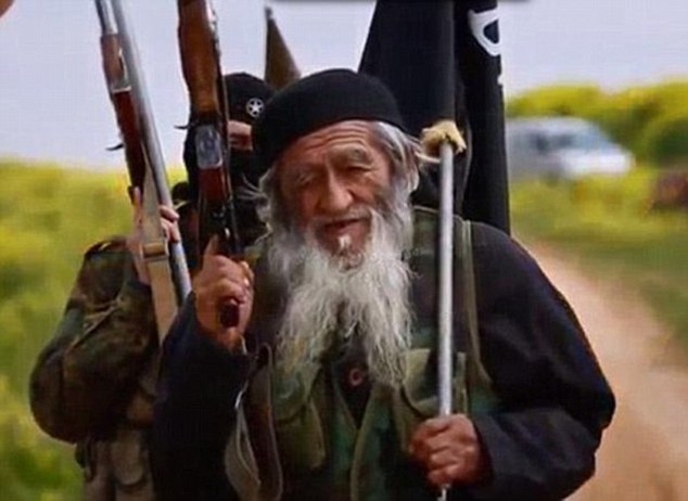 Hình ảnh Muhammed Amin vác súng aka và cầm lá cờ IS