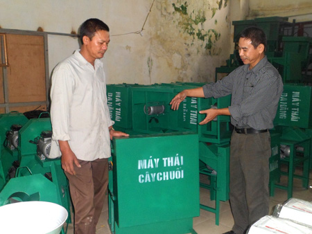 Anh Nguyễn Như Lĩnh (bên phải)và các sản phẩm máy thái củ quả tăng năng suất chăn nuôi