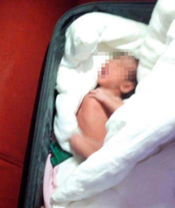 Bé gái sơ sinh người Trung Quốc bị cha ruột giấu dưới đống quần áo nhét trong vali