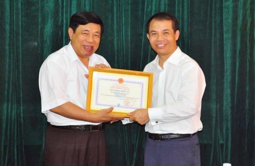 Ông Đặng Khắc Vỹ (phải) nhận bằng khen từ Chủ tịch UBND tỉnh NGhệ An trong lần làm từ thiện trao 1,5 tỷ đồng cho trẻ em bị bệnh tim tại Nghệ An hôm 6/8 vừa rồi.
