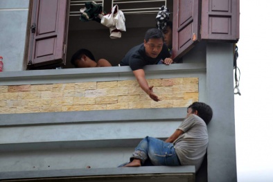 Người đàn ông dân tộc quằn quại trên cửa số tầng 4 ngôi nhà ở Thủ đô
